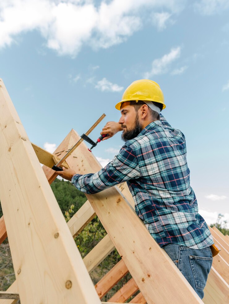 Man adding rafters to a Garage